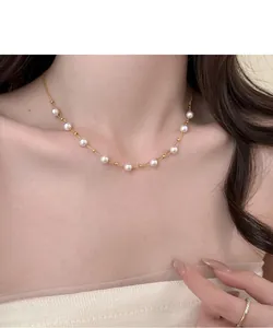 Elegant 18k gold plated pearl choker necklace worn on model for jewelry detail