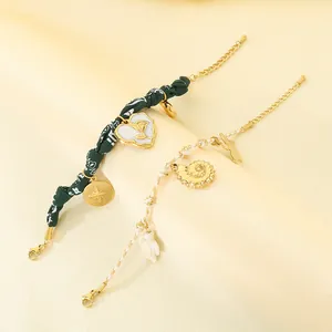 Detailed view of ocean-themed bracelets with floral cloth and braided cotton rope charms.