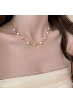 Elegant 18k gold plated necklace with delicate pearls and beads on an Asian model.