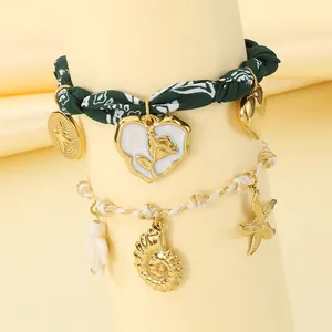 Detail view of summer ocean theme bracelets with conch, starfish, and floral fabric charms