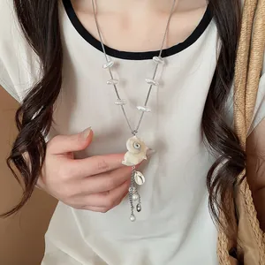 Close-up detail of a stylish sea shell and pearl necklace for summer beach vacation