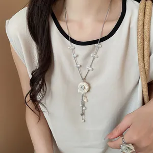 Detail view of sea shell and pearl necklace set for summer beach vacation style.