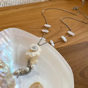 Close-up detail of island style seashell and pearl necklace for summer beach vacation