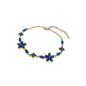 Elegant gold bracelet with blue zircon flowers and marquise drop stones, adjustable chain.