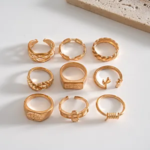 Set of vintage gold-tone rings featuring leaf, antler, and geometric metal designs.