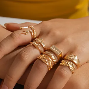 Detailed view of a gold vintage ring set with leaf and antler designs on hand.