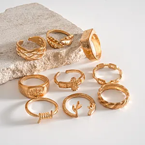 Close-up of a gold vintage ring set featuring intricate leaf antler and braided textures