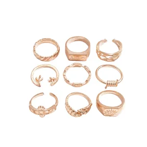 Set of 9 vintage rose gold rings featuring unique leaf antler and geometric designs.