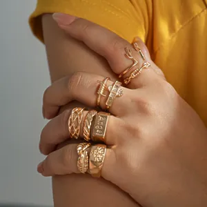 Detailed view of a vintage gold ring set featuring leaf, antler, and twist designs.