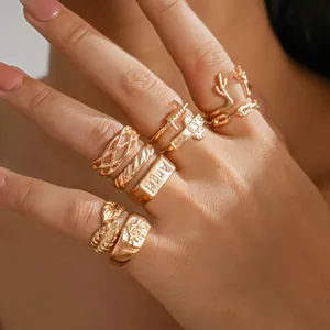 Macro detail of vintage gold ring set featuring leaf and antler designs on fingers