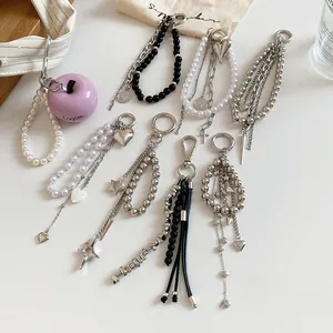 Detailed high-quality view of various stylish heart and pearl beaded keychains in silver.