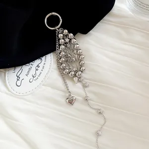 Detailed macro view of a stylish silver beaded keychain with heart and star charms.