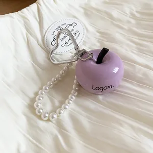 Close-up of purple apple pendant with pearl bead strand and heart carabiner