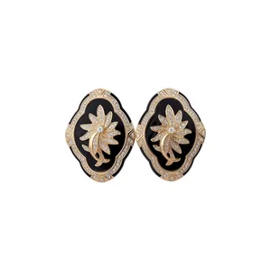 Elegant vintage French style earrings with gold floral motif and black enamel finish