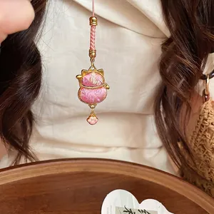 Cute pink cat-shaped embroidered charm pendant with golden frame and hand-woven cord.