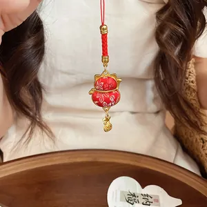 Detailed view of a handmade lucky cat paw pendant with red floral fabric and golden lucky charms