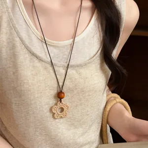 Close-up of a vintage woven floral pendant necklace in bohemian style