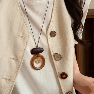 Close-up of retro bohemian long necklace with woven and wooden elements details