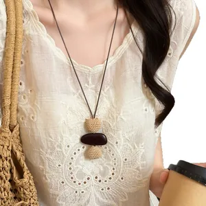 Bohemian style retro ethnic woven long necklace for women worn by an Asian model
