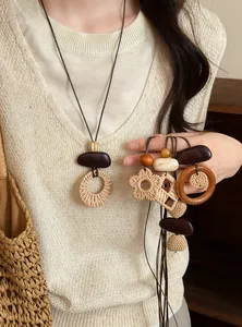 Detailed shot of vintage bohemian woven long necklaces with brown wooden accents