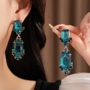 Primer plano de elegantes pendientes colgantes vintage geométricos de cristal azul