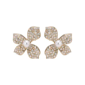 Elegant gold-tone flower stud earrings featuring shimmering zircons and white pearls