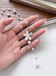 Close-up detail of a delicate Korean style floral pendant necklace with white pearls