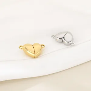 Dettaglio macro di chiusure magnetiche a forma di cuore in finitura oro e argento