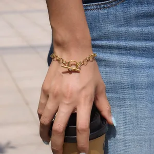Detail of gold-plated stainless steel chunky chain bracelet with toggle clasp on wrist