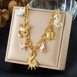 Gold plated ocean charm necklace with starfish, seahorse, and shell pendants for summer beach style