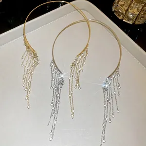 Elegant crystal tassel collar necklace in gold and silver finish shown on a jewelry tray