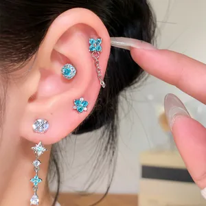 Elegant silver needle flower earrings with turquoise zircon and star dangles on ear