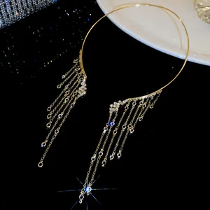 Detailed view of shimmering crystal fringe on elegant gold angel wing choker necklace.