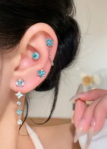 Close-up detail of exquisite zircon flower dangle earrings with blue and clear crystals