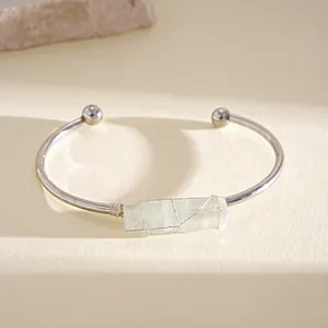 Dettaglio del bracciale rigido in argento con cristallo grezzo irregolare e filo avvolto.