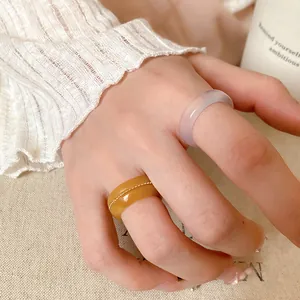 Detailed macro view of the translucent resin rings on a hand, highlighting textures