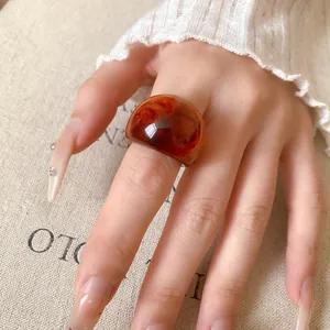 Detailed macro view of translucent amber resin ring featuring unique marbled swirled texture