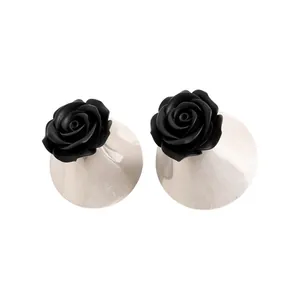 Elegant black resin rose stud earrings featuring silver finish oval bases for women