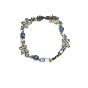 Elegant silver bracelet featuring blue gemstones and sparkling floral motifs for women.