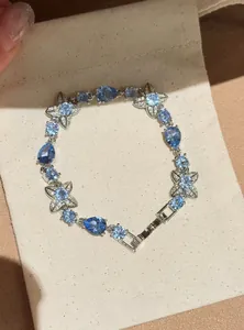 Close-up view of a sweet blue sparkling crystal flower bracelet on a linen pouch