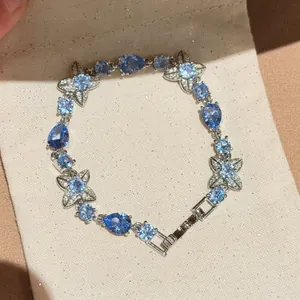 Detail view of the elegant blue flower bracelet with teardrop and round sparkling stones