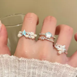Ocean starfish and shell rings with pearls shown as stackable index finger jewelry