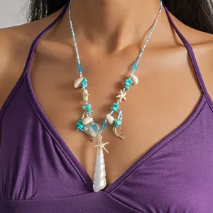 Detail view of a beach-style shell and starfish beaded necklace worn by a model