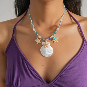 Close-up of beach vacation style beaded necklace with shell and starfish charms