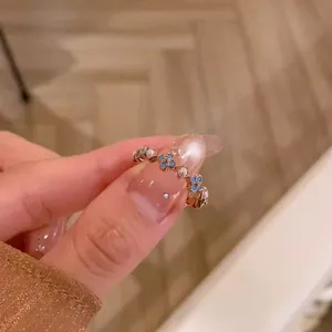 Detailed macro view of a vintage French style gold ring with turquoise flowers and pearls