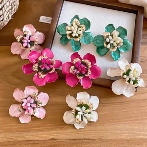 Vintage enamel flower stud earrings with intricate gold-edged petal details