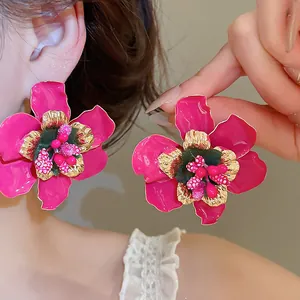 Vintage style magenta floral drop oil earrings with gold edges and colorful bead center