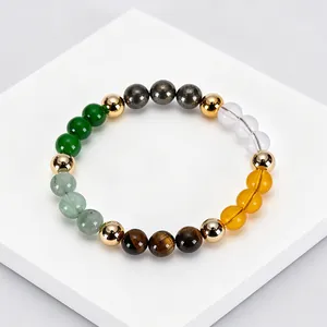 Detail of handmade gemstone bracelet featuring citrine, tiger eye and gold spacer beads