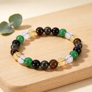 Detailed view of mixed natural stone bracelet featuring citrine and tiger's eye on wood.