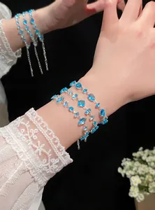 Detail shot of three elegant adjustable zirconia bracelets with vibrant blue stones.